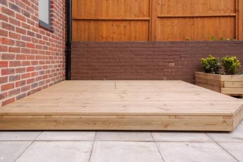 Newly built wooden deck in backyard.